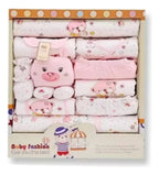 Ajuar de bebé rosa con prendas, textiles y peluche